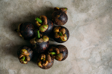 Fresh mangostine. Fresh Tropical Fruits. On a grey background. Top view.
