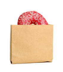 Paper bag with donut on white background. Space for design