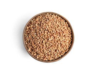 Bowl with uncooked buckwheat on white background, top view