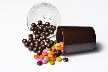 Tasty chocolate balls in pot isolated on a white background