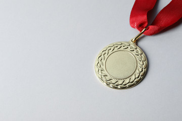 Gold medal with space for design on light background. Victory concept