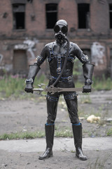 Fototapeta na wymiar Adult kinky man dressed in fetish latex rubber costume with black mask