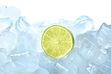 Fresh lime on ice cubes against white background