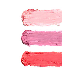 Strokes of lipstick on white background, top view