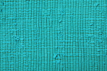 Color woven carpet texture as background, top view
