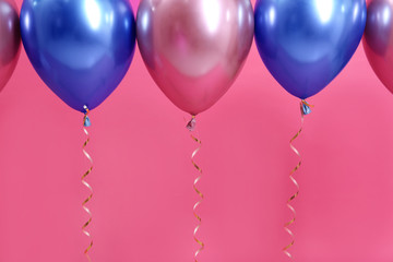Bright balloons with ribbons on color background. Space for text
