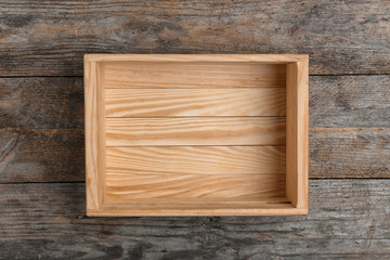 Empty crate on wooden background, top view