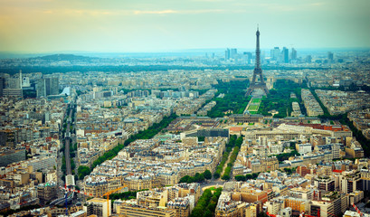 Panoramic aerial view Parisian buildings with Eiffel tower and Champ de Mars.