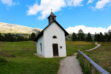 Fototapeta na wymiar Small chapel in a village of the Dolomites, Italy