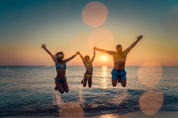 Happy family jumping in the sea