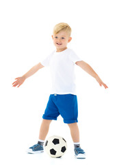 Little boy is playing with a soccer ball.