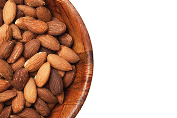 Raw almond nuts pattern. Helathy diet background. Wooden bowl isolated on white.