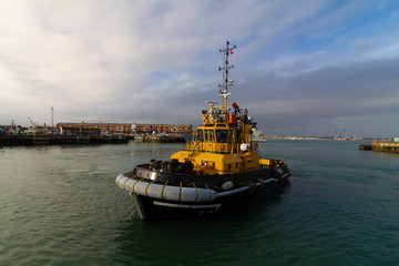 Yellow tug is in port