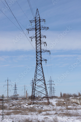 High Voltage Power Tower And Silhouette Power Lines At