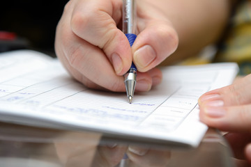 in female fingers the pen with which the document is signed
