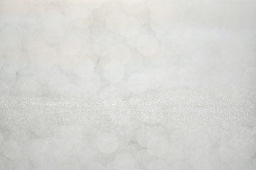 Shiny silver foil color glitter decorative texture paper with boheh effect: Bright brilliant festive metallic textured empty wallpaper backdrop: Tin metal material for holiday craft design decoration