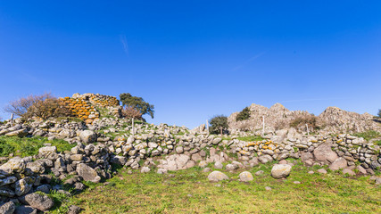 Remains of nuraghe or fortress from the bronze age at Archeological site of Tamuli, Sardinia island, Italy