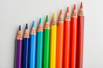 Colored pencils with funny smiles