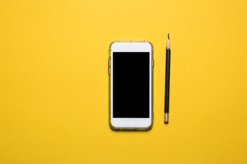 Phones, communication devices placed on a yellow background Technology concept With copy space