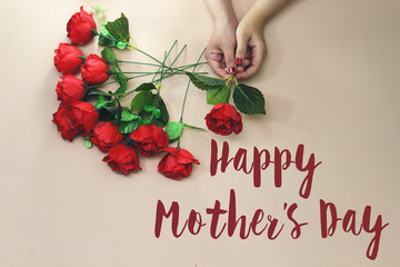 woman hand holding a beautiful rose with happy mother's day concept