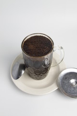 A glass of kopi tubruk, a traditional coffee serving ini Indonesia