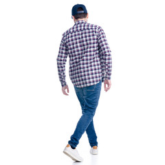Fototapeta premium A man in jeans, shirt and cap goes walking on a white background. Isolation, back view