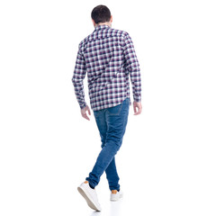 Naklejka premium A man in jeans shirt goes walking on a white background. Isolation, back view