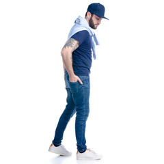 Man in jeans, t-shirt and cap walking smiling on white background isolation