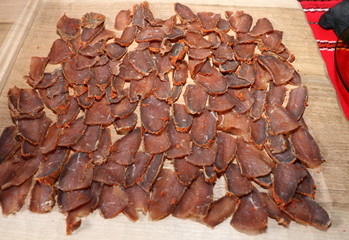 Slimly cut pieces of homemade pastry, on a wooden tray. Traditional Bulgarian Meat
