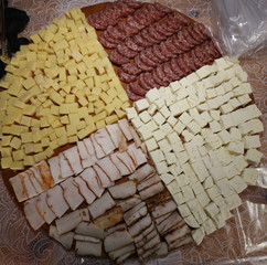 Thin cut pieces of homemade sausages, fresh bacon, cheese and yellow cheese. Traditional Bulgarian meat