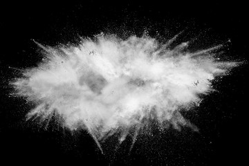White powder explosion isolated on black background. White dust particles splash.Color Holi...