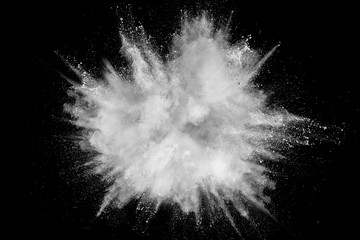 Fototapeta White powder explosion isolated on black background. White dust particles splash.Color Holi Festival. obraz