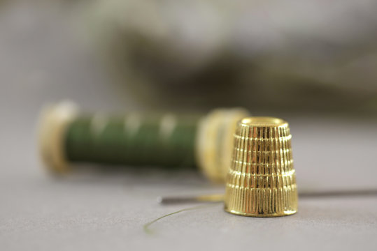 Close up of thimble and sewing thread
