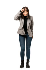 A full-length shot of a Young business woman looking far away with hand to look something over isolated white background