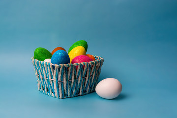 Fototapeta na wymiar Colorful Easter eggs in basket on wooden background