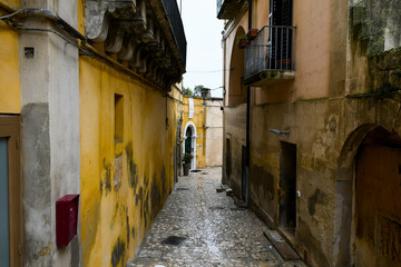 Narrow street between old houses on a rainy day - 251033707