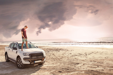 The guy on the beach.Drove to the beach by car.Sunset guy and car