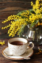 Spring Tea Party against the backdrop of a mimosa flower