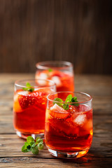 Fresh summer cocktail with ice, strawberry and mint