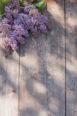 lilac on old wooden background in sunlight