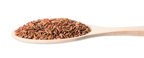Brown rice in a wooden spoon on a white background