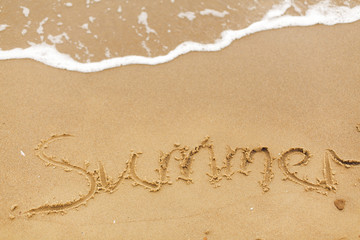 Hello summer concept. Summer text written on sandy beach and sea waves. Relaxing on tropical island. Summer vacation concept