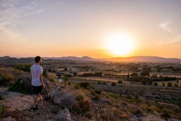 Fototapeta premium Man watching the sunset in a mountain
