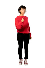 Fototapeta premium A full-length shot of a Short hair girl with red sweater frustrated and pointing to the front over isolated white background
