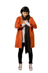 A full-length shot of a Short hair woman with coat having a pain in the heart over isolated white background