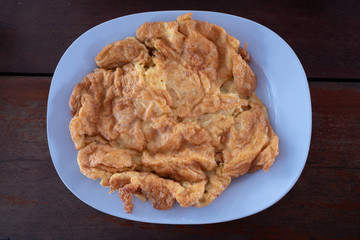 Delicious omelette on blue plate., Thai style omelette.  