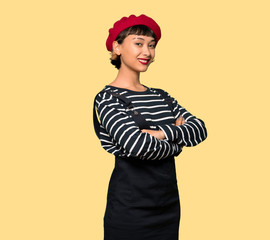 Young woman with beret with arms crossed and looking forward