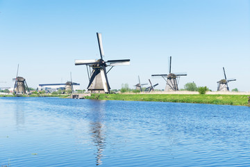 Naklejka premium dutch windmill over river waters
