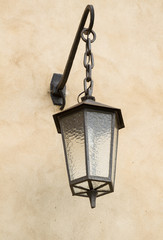 Naklejka premium Iron old lantern on a wall in Krakow