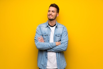 Fototapeta premium Handsome man over yellow wall Happy and smiling
